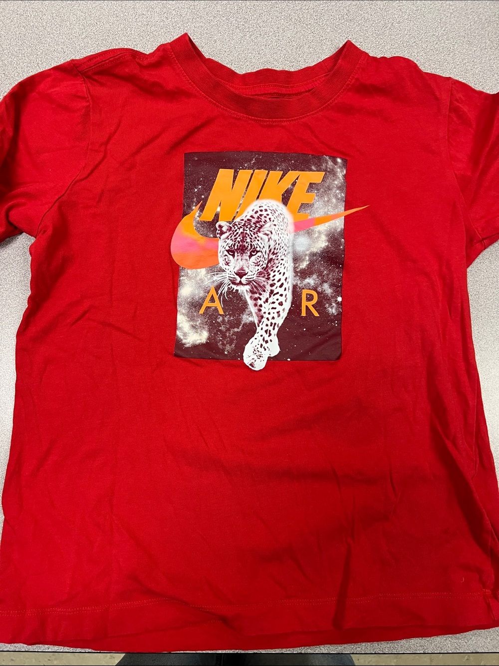 Nike Red Tee with Orange-Yellow Swoosh and White Leopard Graphic